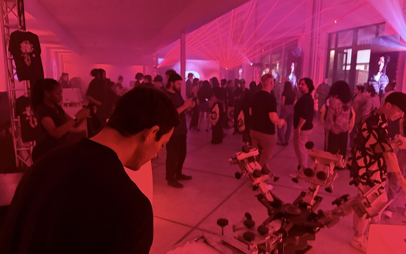 Crowded night event lit in red with a customization carousel in the foreground
